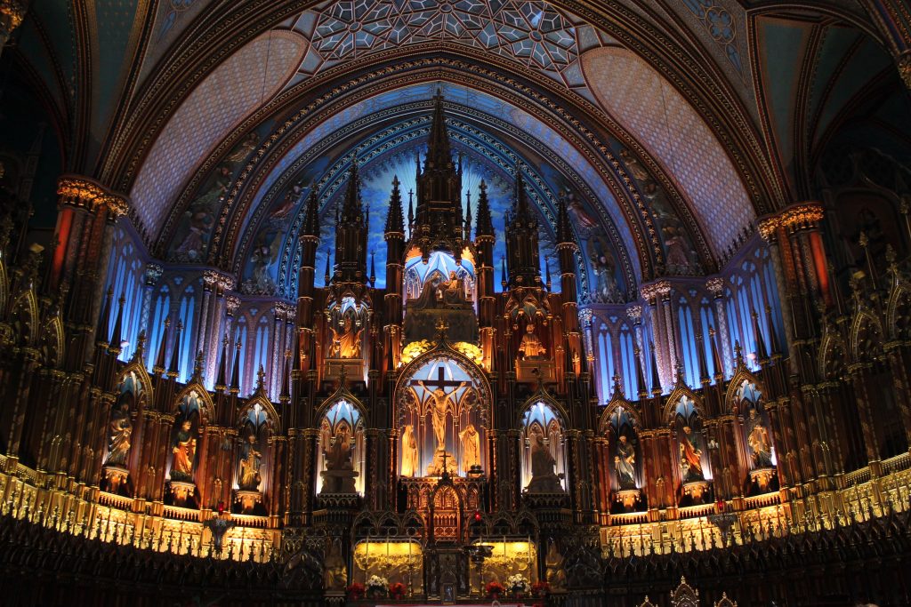 A photo of Notre Dame in Montreal, where you don't need to speak French because they have English services and daily tours.